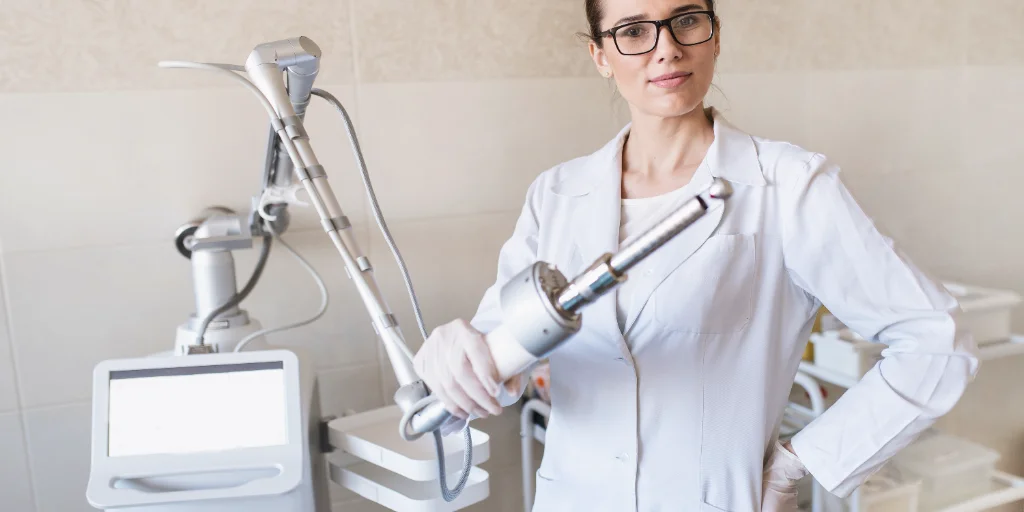 female doctor holds in her hands a carbon dioxide laser